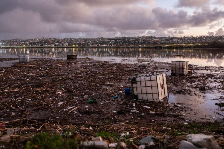 Trash flows along a section of the Tijuana River following days of heavy rains and flooding in San Ysidro on Feb. 2, 2024. Photo by Adriana Heldiz, CalMatters