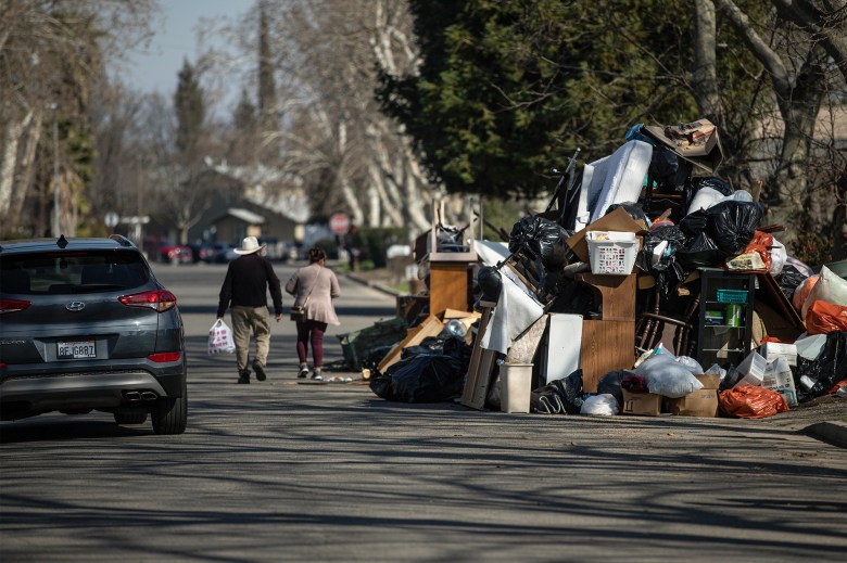 Debris and water damaged furniture on the side of a road in Planada on Feb. 8, 2023. The town was hit by flooding in January after heavy rainstorms rolled through the area. Photo by Larry Valenzuela, CalMatters/Catchlight Local