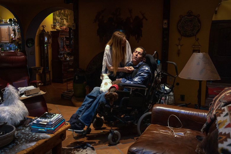 Jen Saeta, a primary caregiver for Josh, shares a moment with her brother in the family’s living room at their home in Santa Rosa Valley, on March 11, 2024. In 2017, Josh visited West Hills Hospital for abdominal pain and the doctor ordered him to be sent to the ICU. Staff never transferred him and he had a heart attack and suffered a catastrophic brain injury as a result. His family has taken care of him since, but over time they’ve learned more details about the conditions in the hospital that caused them to file the lawsuit. Photo by Alisha Jucevic for CalMatters