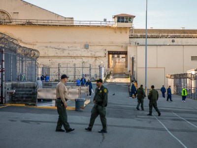 Guards and inmates in the yard at San Quentin State Prison on March 17, 2023. Photo by Martin do Nascimento, CalMatters