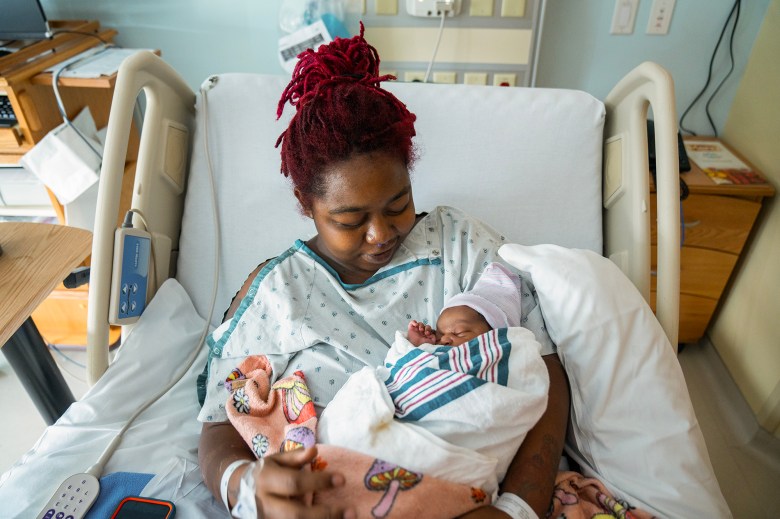 The morning after giving birth, Detranay Blakenship holds her child, Myla Sqmone Grace Thimbrel, while recovering at Martin Luther King Community Hospital in Los Angeles, on March 23, 2024. Photo by Jules Hotz for CalMatters