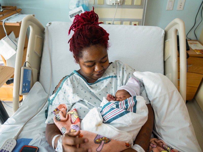 The morning after giving birth, Detranay Blakenship holds her child, Myla Sqmone Grace Thimbrel, while recovering at Martin Luther King Community Hospital in Los Angeles, on March 23, 2024. Photo by Jules Hotz for CalMatters