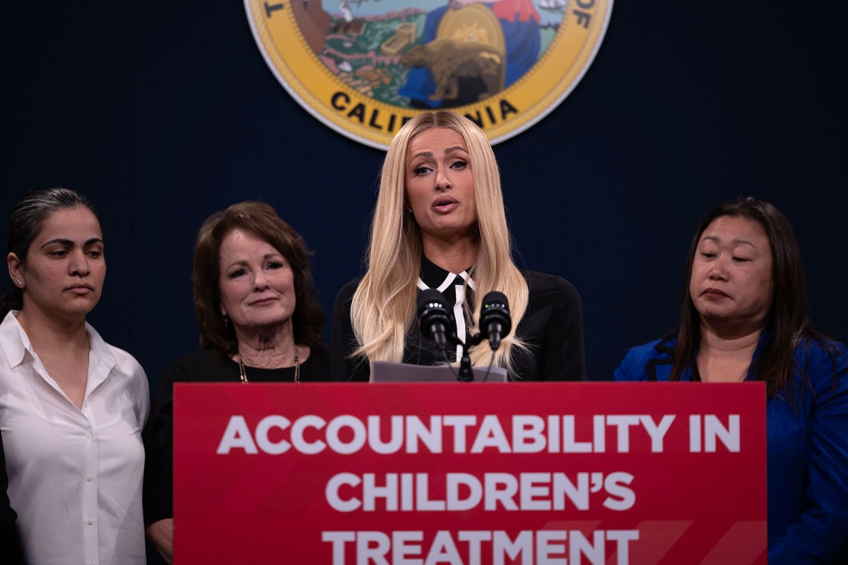 Flanked by legislators, Paris Hilton speaks in support of Senate Bill 1043 during a press conference at the Capitol Annex Swing Space on April 15, 2024. SB 1043 would require more transparency for children's treatment facilities that are licensed in California. Hilton spoke of her traumatic experience during her teenage years at similar facilities. Photo by Miguel Gutierrez Jr., CalMatters