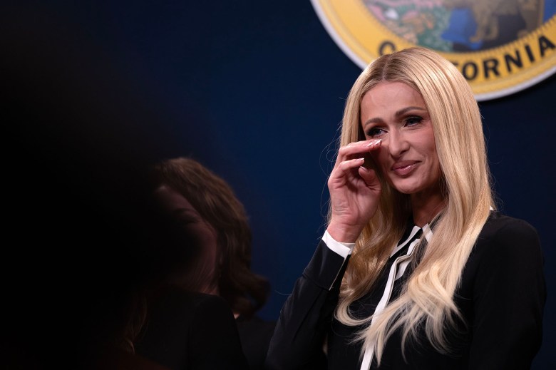 Paris Hilton wipes a tear from her eye after speaking in support of Senate Bill 1043 during a press conference at the Capitol Annex Swing Space on April 15, 2024. SB 1043 would require more transparency for children's treatment facilities that are licensed in California. Hilton spoke of her traumatic experience during her teenage years at similar facilities. Photo by Miguel Gutierrez Jr., CalMatters