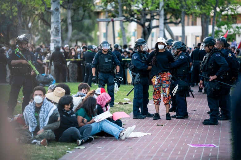 A pro-Palestinian protester is arrested after being surrounded by LAPD officers during a protest in Alumni Park at the University of Southern California in Los Angeles on April 24, 2024. Photo by Jules Hotz for CalMatters