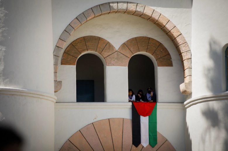 Protestors display a Palestinian flag at Hepner Hall during a pro-Palestinian protest at San Diego State University in San Diego on April 30, 2024. Photo by Kristian Carreon for CalMatters