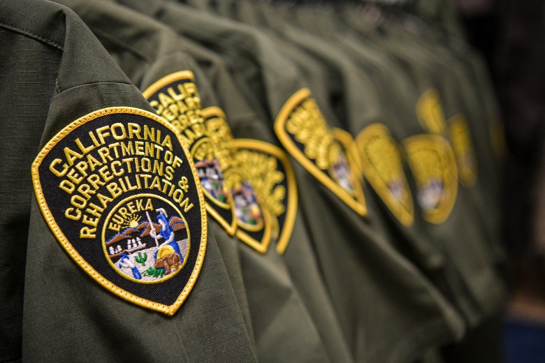 Rows of California Department of Corrections and Rehabilitation uniforms hang at Halby’s on May 8, 2023 in Blythe. Photo by Pablo Unzueta for CalMatters