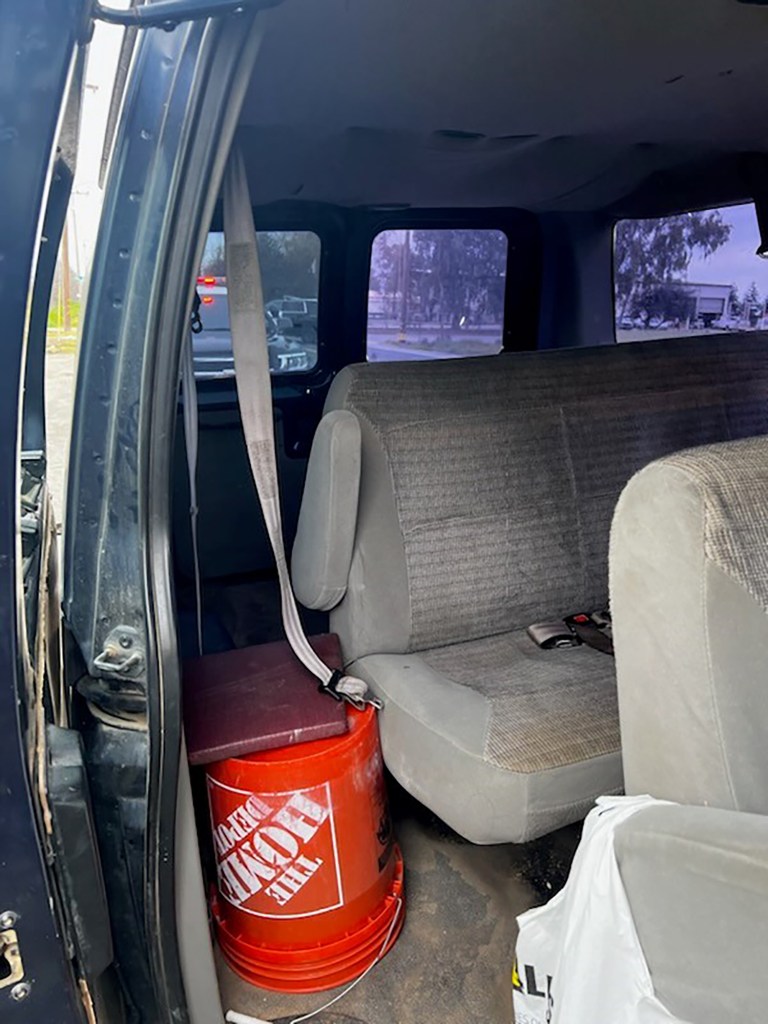 Photos taken of a vehicle pulled over by California Highway Patrol packed with 10 workers despite only having seats for seven passengers. One worker sits on a bucket while another lies behind the back row. Photo courtesy of California Highway Patrol