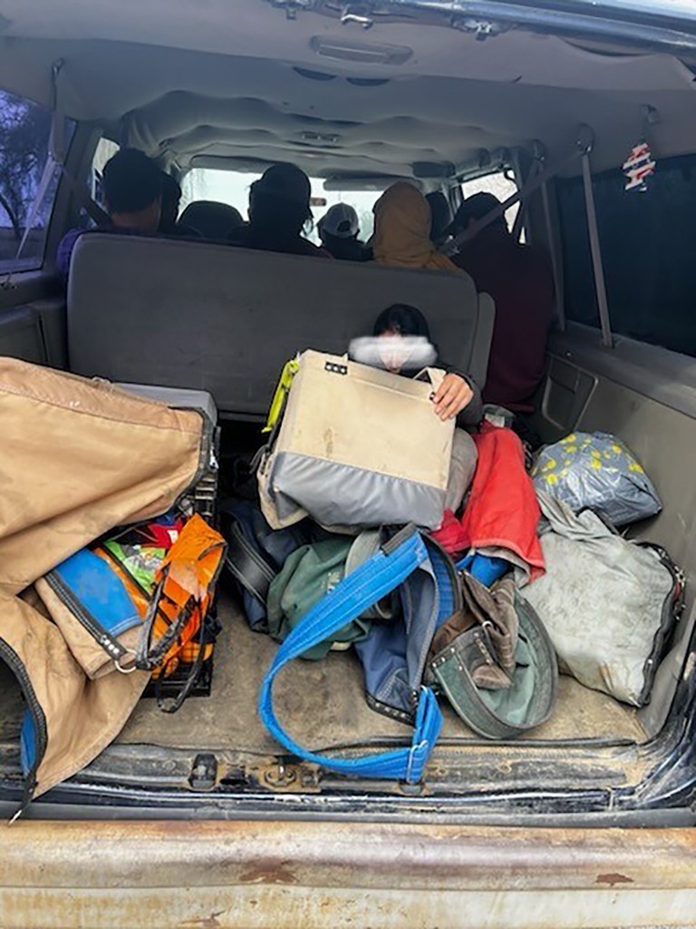 Photos taken of a vehicle pulled over by California Highway Patrol packed with 10 workers despite only having seats for seven passengers. One worker sits on a bucket while another lies behind the back row. Photo courtesy of California Highway Patrol