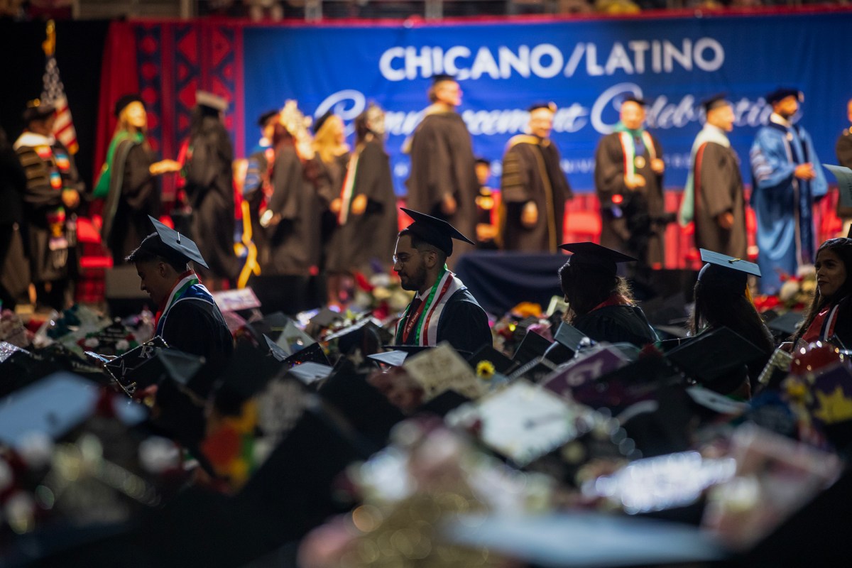 Student graduates walk through the aisles to receive their degrees at the Fresno State Chicano/Latino Commencement Celebration in the Save Mart Center in Fresno on May 18, 2024. Photo by Larry Valenzuela, CalMatters/CatchLight Local