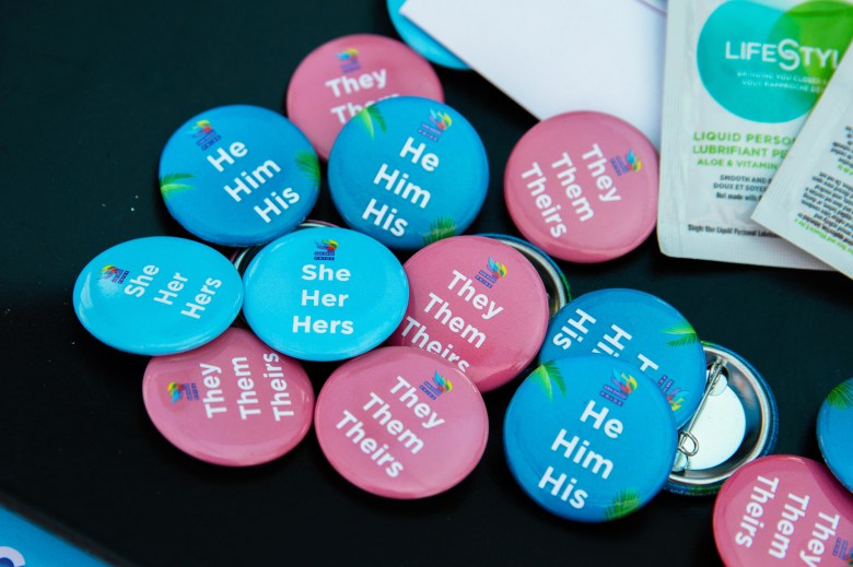 Buttons with different pronouns at the We Care Health Fair in San Diego on May 18, 2024. Photo by Adriana Heldiz, CalMatters