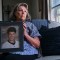 Susan Ottele holding a photo of her son Adam Joseph Collier who committed suicide while in solitary confinement in a California state prison. Photo by Tojo Andrianarivo for CalMatters