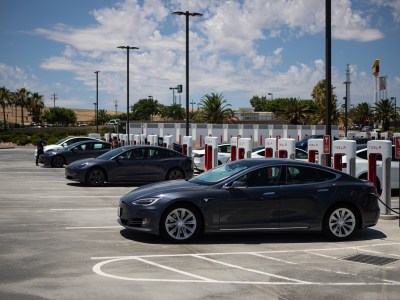 Tesla vehicles charging at the Tesla Supercharger lot in Kettleman City on June 23, 2024. Photo by Larry Valenzuela, CalMatters/CatchLight Local