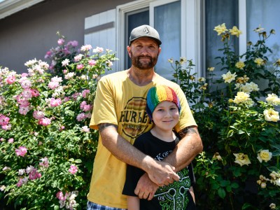 Will Hollman with his son outside of his home in the San Fernando Valley. "I love my kids and it is my duty to be a parent," Hollman said. "I'm fighting a lot of battles." Pablo Unzueta for CalMatters