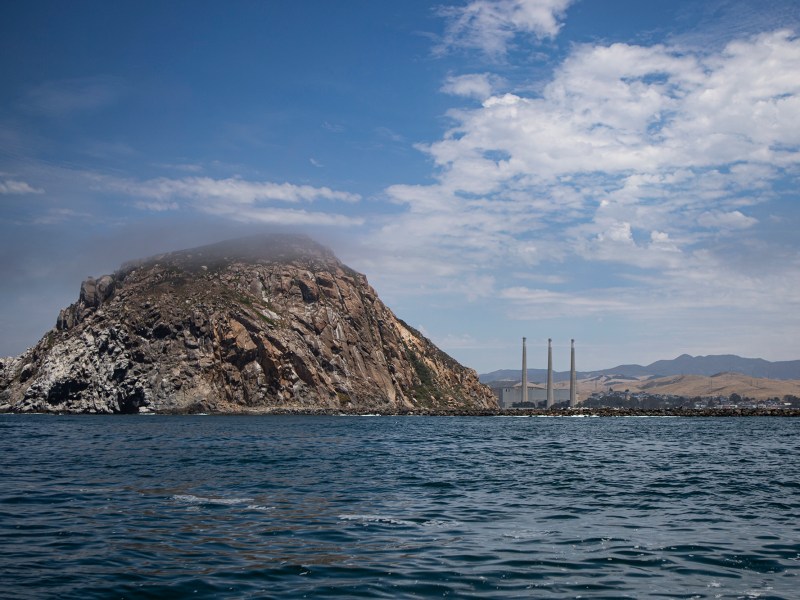 Afternoon fog slowly covers Morro Rock, a volcanic plug millions of years old and a major landmark of the community of Morro Bay on July 18, 2023. The federal government offered an offshore wind lease including 376 square miles of floating wind farms off Morro Bay. Photo by Larry Valenzuela, CalMatters/CatchLight Local