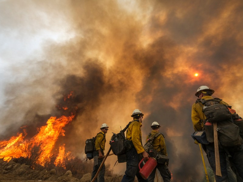 Firefighters watch as the Fairview Fire burns on a hillside near Hemet on Sept. 8, 2022. Photo by Ringo H.W. Chiu, AP