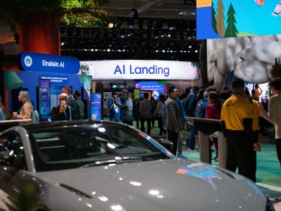 A conference hall with attendees and colorful signage related to artificial intelligence.