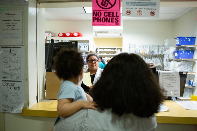 A patient waits in line to pick up a prescription at La Clinica in Oakland on Sept. 26, 2019. Photo by Anne Wernikoff for CalMatters