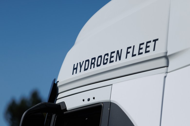 A close-up view of a commercial truck with the words "hydrogen fleet" above the driver seat window.