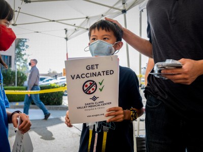 Matthew Yip, 8, waits in line to receive a Pfizer COVID-19 vaccine in San Jose on Nov. 3, 2021. AP Photo/Noah Berger