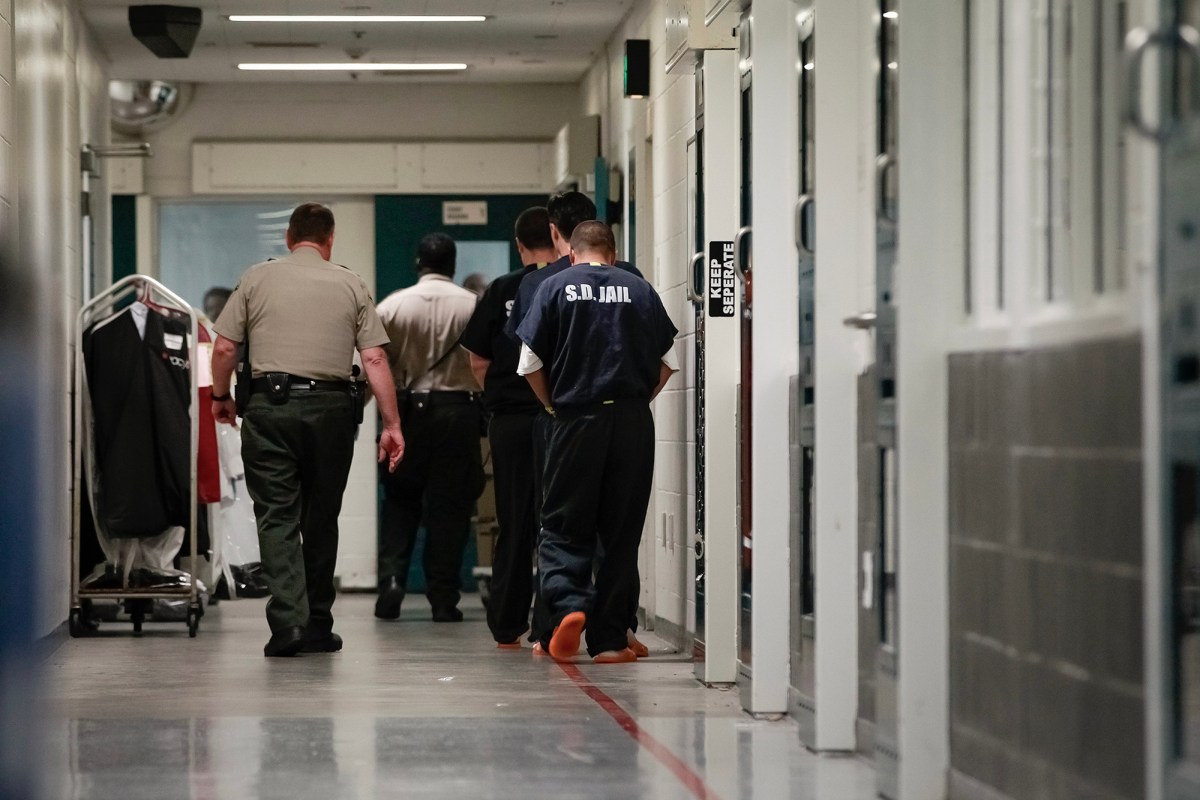 Sheriff's Deputies escorts inmates down a secured hallway at downtown Central Jail in San Diego in 2015. Photo by Nelvin C. Cepeda, The San Diego Union-Tribune via AP Photo