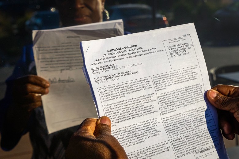 Nancy Wiles holds her eviction notice on Dec. 4, 2023. Photo by Manuel Orbegozo for CalMatters