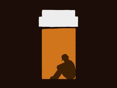 Illustration of a silhouette of a person wearing a hard hat, crouched and sitting inside an orange prescription bottle